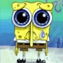 spongebob squarepants is crying with a tear coming out of his nose while standing on the beach .