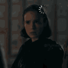 a close up of a woman 's face in a dark room with a loading bar on her head .
