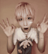 a young boy with pink hair is making a funny face