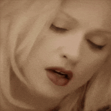 a close up of a woman 's face with her mouth open
