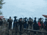 a blurry picture of a group of soldiers with bows and arrows