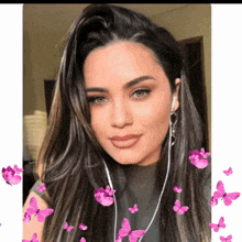 a woman wearing ear buds is surrounded by pink butterflies on a white background