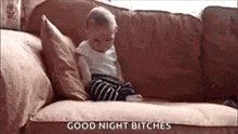a baby is sitting on a couch with the words `` good night bitches '' .