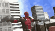 a man in a deadpool costume is standing in front of a city
