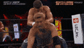 two men in a wrestling ring with a sign that says lec inc