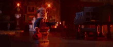 a lego batman is standing in front of a recording studio .