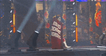 a wrestler with a red cape that says mexico tiger on it
