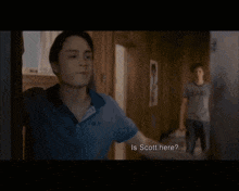 a man in a texas shirt is running towards another man in a room
