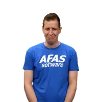 a man in a blue afas software shirt is making a funny face