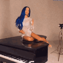 a woman with blue hair is sitting on a piano with her legs crossed