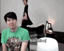a man in a green t-shirt says boom niki minaj