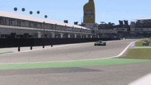 a race car is driving down a track with a large yellow bottle in the background that says castrol on it