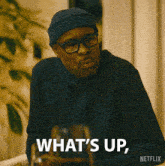 a man wearing a beanie and glasses says what 's up