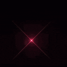 a pink circle with a yellow center is surrounded by a dark background