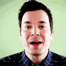 a close up of a man 's face with a green background .