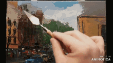 a person is painting a picture with a spatula and the words made in animatica on the bottom