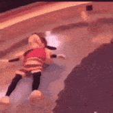 a stuffed mickey mouse is floating in a pool .