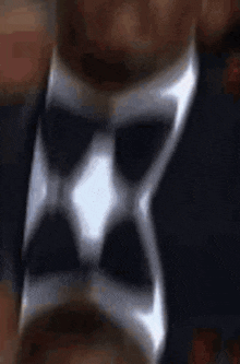 a close up of a man wearing a suit and tie .