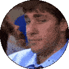 a man in a blue shirt and tie is looking down