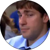 a man in a blue shirt and tie is looking down