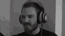 a black and white photo of a man wearing headphones with the website gifs.com at the bottom
