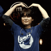 a person wearing a blue shirt that says lamo 's on it