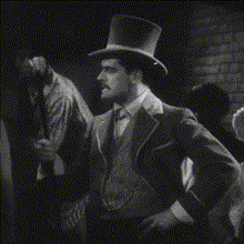 a man in a top hat and suit is standing in a crowd
