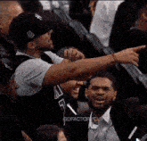 a man in a ny hat is pointing at something