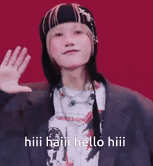 a person wearing a hat and a jacket is waving their hand and says hiii haiii hello hiii .