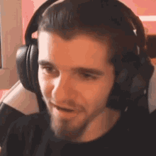 a man wearing headphones is making a funny face .