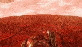a computer generated image of a red landscape with a robot standing in the foreground