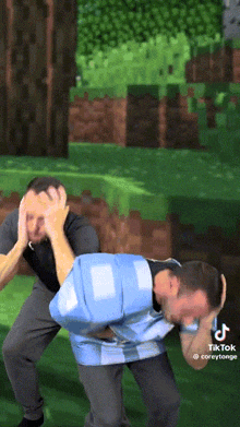 two men are standing in front of a minecraft background and one of them is wearing a blue shirt