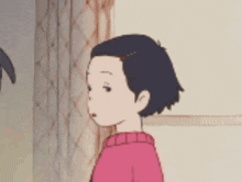 a little girl in a pink sweater is looking at something