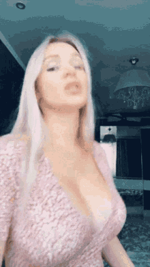 a woman in a pink dress with a plunging neckline