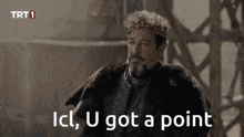 a man wearing a crown and a fur coat says " ici , u got a point "