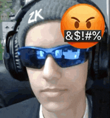 a man wearing headphones and sunglasses has a smiley face on his forehead .
