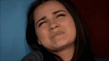 a woman is holding a baby in her arms and crying