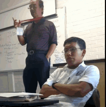 a man standing in front of a white board that says poco