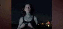 a woman with a tattoo on her neck is making a heart shape with her hands