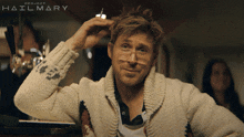 a man wearing glasses and a sweater with project hailmary on the bottom
