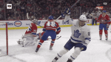 a hockey game is being played in front of an esso ad