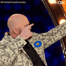 a man wearing a money jacket has a badge that says 100