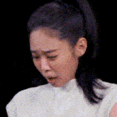 a close up of a woman making a funny face with her eyes closed .