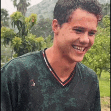 a young man wearing a black shirt with the letter l on it