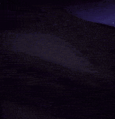 a close up of a person 's hand holding a sword in a dark room