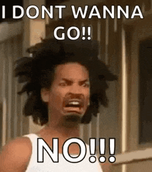 a man with curly hair is making a funny face and saying `` i dont wanna go ! ''
