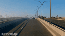 a car is driving on a highway with motorweek.org written on the bottom right