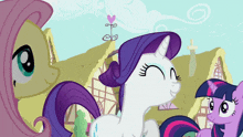 a group of ponies are standing next to each other and one of them has a purple mane and tail