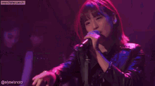 a group of women are performing on a stage with the website www.honeycam.tv visible in the background