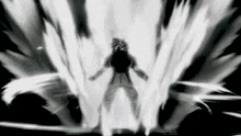 a black and white image of a person standing in front of a light coming out of the ground .